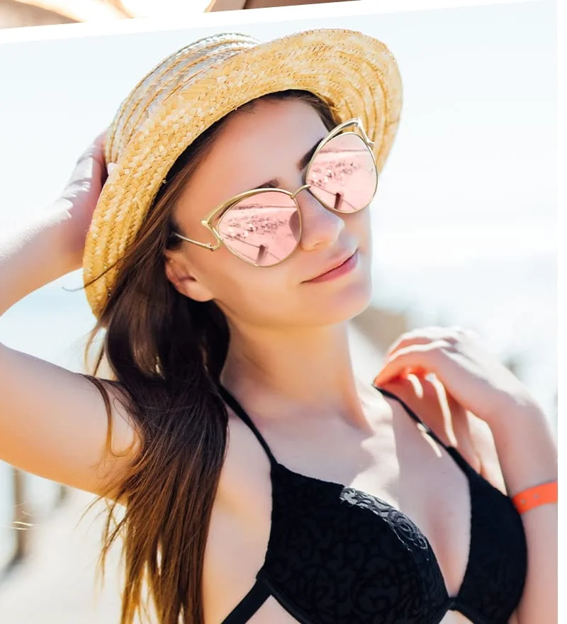 The cat-eye in pink mirror, under a straw hat